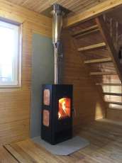 Популярный камин с дровницей Сибирь 8 в интерьере фото в Бобруйске