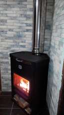 Стальной недорогой камин Теплодар ОВ-120 (угловой) фото в интерьере в Бобруйске